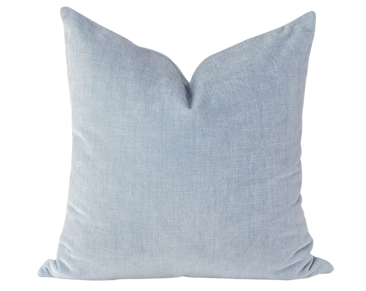 A solid light blue velvet pillow cover.